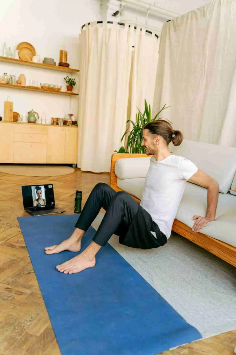 man working out in front of laptop